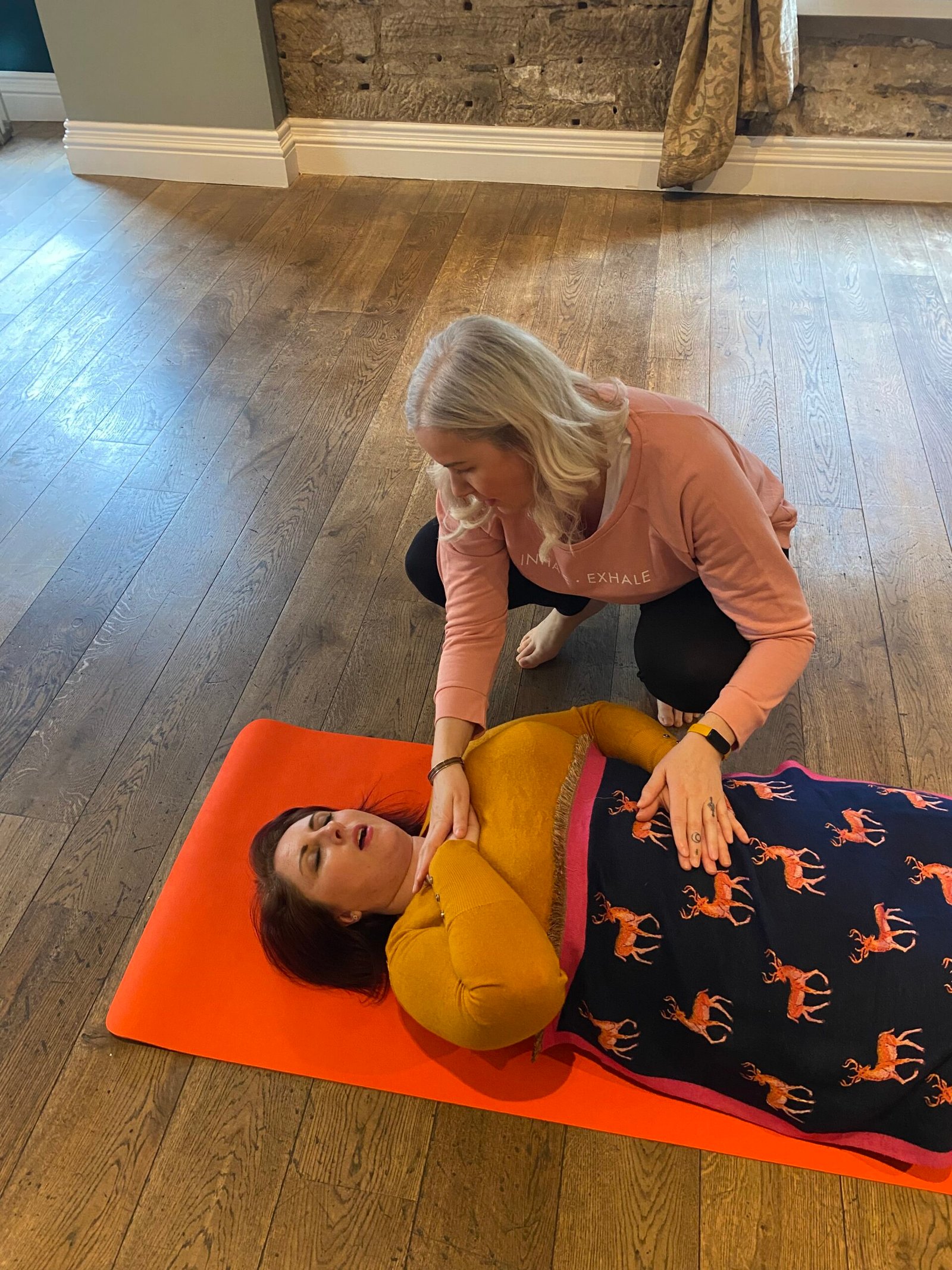 Victoria Cunningham guiding a breathwork session on the mat
